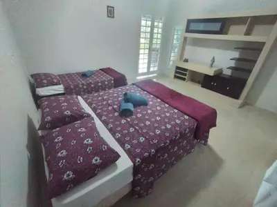 Uma cama ou camas num quarto em Linda casa em Guaramiranga