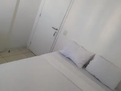 Uma cama ou camas num quarto em Quartos - Cíntia