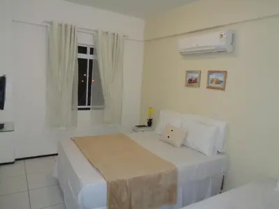 Uma cama ou camas num quarto em Brisa Brasil Residence