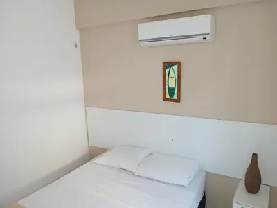 Uma cama ou camas num quarto em Brisa Brasil Residence