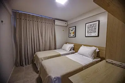 Uma cama ou camas num quarto em Flat Hotel Mercure Vista Mar
