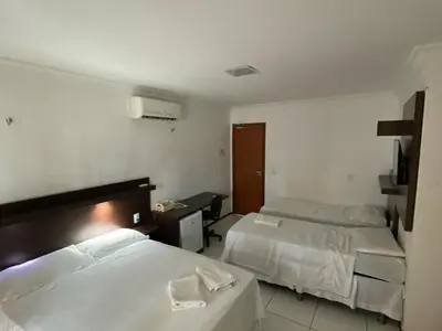 Uma cama ou camas num quarto em Hotel Sol Brasil