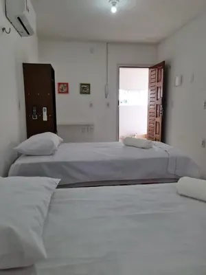 Uma cama ou camas num quarto em Pousada Jereissati