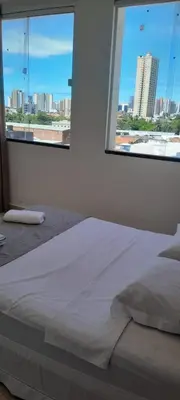 Uma cama ou camas num quarto em Central Palace Hotel