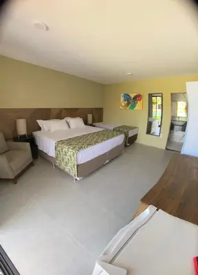 Uma cama ou camas num quarto em CHEZ TUPÃ SUÍTES