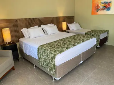 Uma cama ou camas num quarto em CHEZ TUPÃ SUÍTES