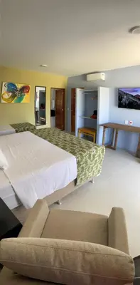Uma cama ou camas num quarto em CHEZ TUPÃ SUÍTES