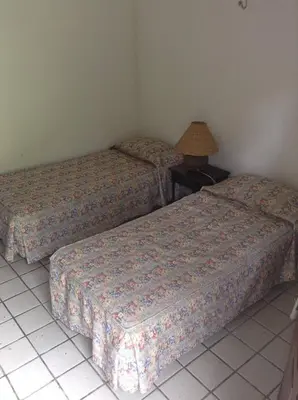 Uma cama ou camas num quarto em Chalé das Helicôneas - Suítes