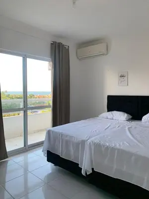 Uma cama ou camas num quarto em Apartamentos Cumbuco Condomínio Vila Real
