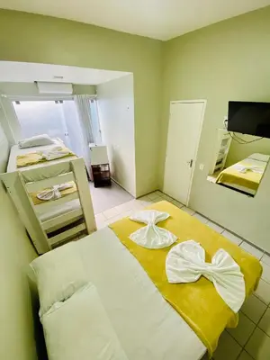 Uma cama ou camas num quarto em Felicità Praia Hotel