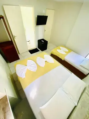 Uma cama ou camas num quarto em Felicità Praia Hotel