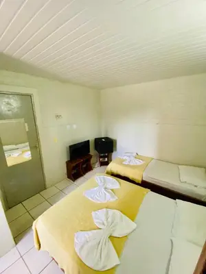 Uma cama ou camas num quarto em Felicità Praia Hotel