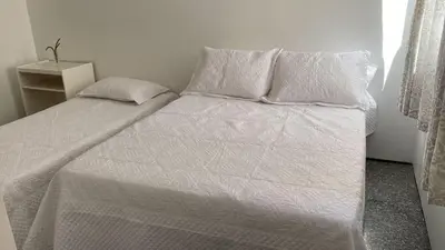 Uma cama ou camas num quarto em Apartamento Atlântico