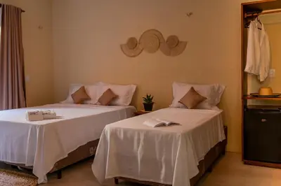 Uma cama ou camas num quarto em Pousada Rota do Kite Preá