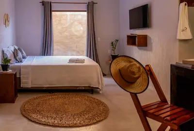 Uma cama ou camas num quarto em Pousada Rota do Kite Preá