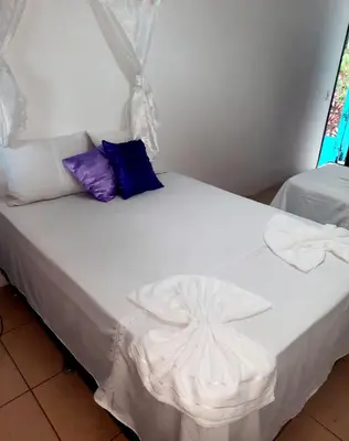 Uma cama ou camas num quarto em Pousada dos Anjos Paracuru