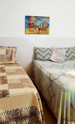 Uma cama ou camas num quarto em Pousada dos Anjos Paracuru