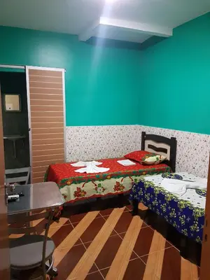 Uma cama ou camas num quarto em Pousada Pouso Feliz