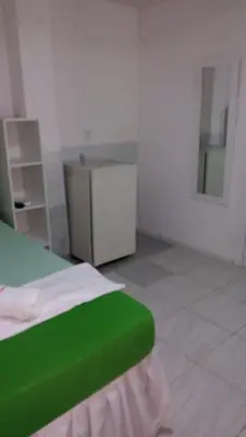 Uma cama ou camas num quarto em Pousada Brenda