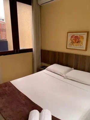 Uma cama ou camas num quarto em Ocean Praia Hotel