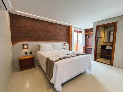 Uma cama ou camas num quarto em Kamai Lodge Icaraí