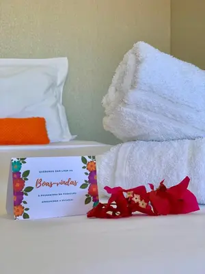 Uma cama ou camas num quarto em Pousadinha no Paracuru