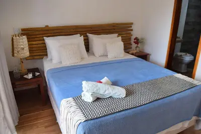 Uma cama ou camas num quarto em Hospedaria Villa Água de Côco Jericoacoara