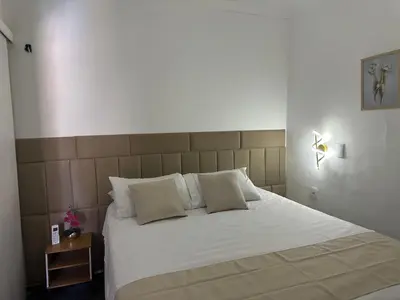 Uma cama ou camas num quarto em Via Venetto Feirinha Beira Mar