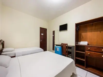 Uma cama ou camas num quarto em Hotel Netuno Beach