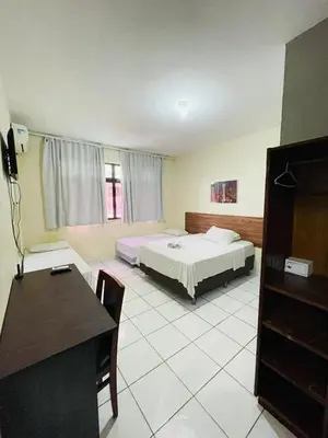 Uma cama ou camas num quarto em Hotel Netuno Beach