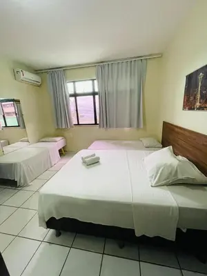 Uma cama ou camas num quarto em Hotel Netuno Beach