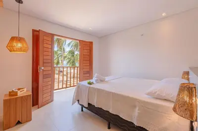 Uma cama ou camas num quarto em Casa LadoMar em Mundaú por Carpediem