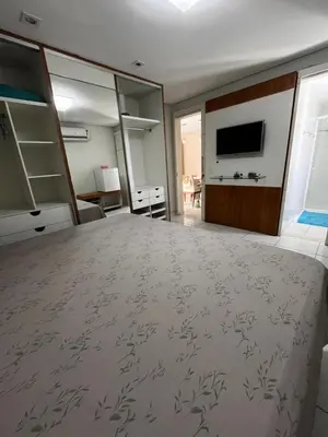 Uma televisão e/ou sistema de entretenimento em Homestay Fortaleza