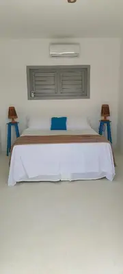Uma cama ou camas num quarto em Pontal Praia Suítes