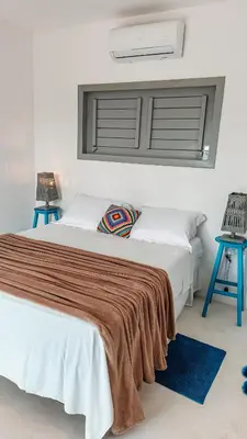 Uma cama ou camas num quarto em Pontal Praia Suítes
