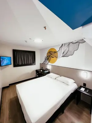 Uma cama ou camas num quarto em WA HOTEL FORTALEZA