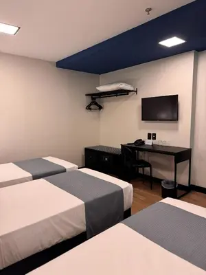 Uma cama ou camas num quarto em WA HOTEL FORTALEZA