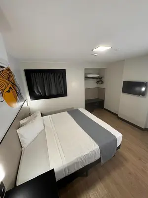 Uma cama ou camas num quarto em WA HOTEL FORTALEZA