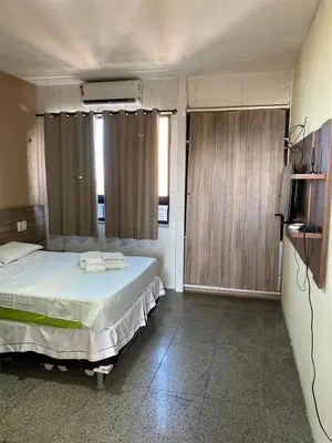 Uma televisão e/ou sistema de entretenimento em Tabajara Residence Service