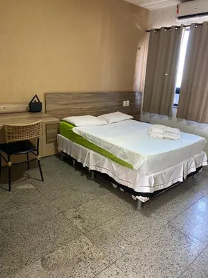 Uma cama ou camas num quarto em Tabajara Residence Service