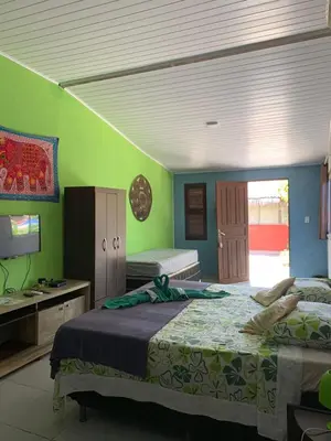 Uma cama ou camas num quarto em Pousada Villa Flamboyant