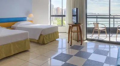 Uma cama ou camas num quarto em Iate Plaza Hotel