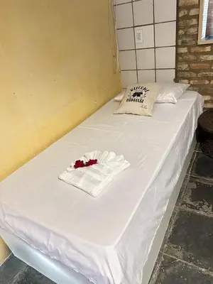 Uma cama ou camas num quarto em Pousada Sol Nascente