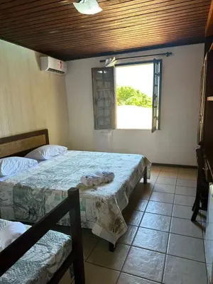 Uma cama ou camas num quarto em Pousada Navegantes Beach