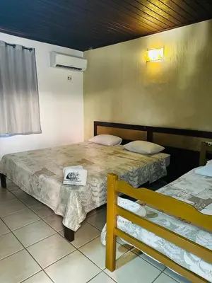 Uma cama ou camas num quarto em Pousada Navegantes Beach