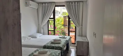 Uma cama ou camas num quarto em Varandas do Mar pé na areia