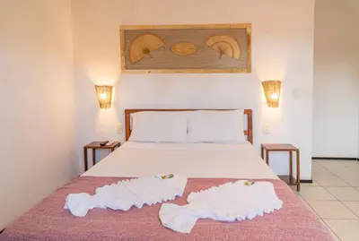 Uma cama ou camas num quarto em Pousada Villa Tomasi