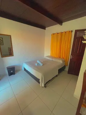 Uma cama ou camas num quarto em Pousada Tropicalia