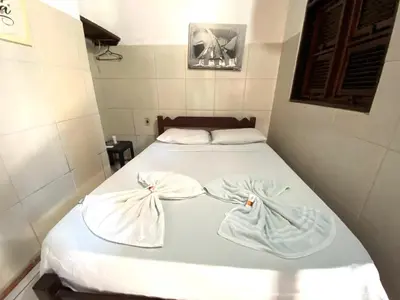 Uma cama ou camas num quarto em Pousada Tropicalia