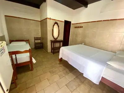 Uma cama ou camas num quarto em Pousada Tropicalia